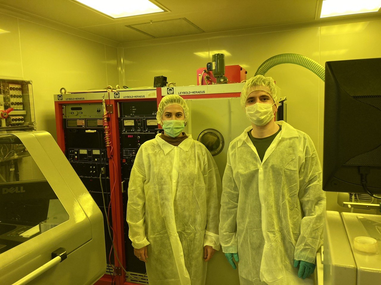Stanko Nedić and a colleague working beside deposition equipment in a cleanroom